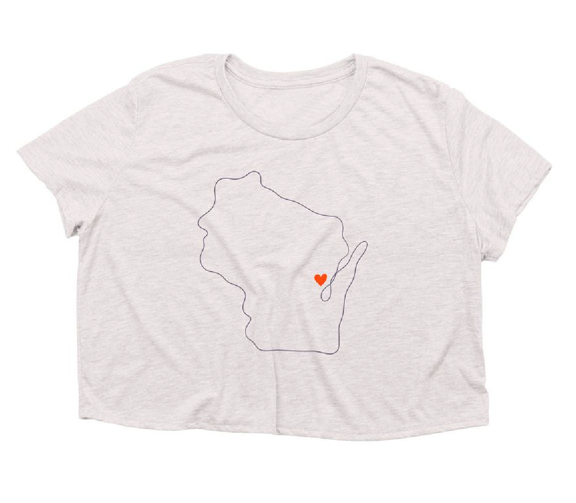A light heather gray short-sleeve t-shirt with a graphic of the outline of the state of Wisconsin, featuring a small red heart near the center, displayed on a solid white background.